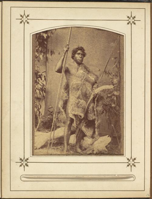 Studio portrait taken in ca. 1866 of Freddy Wheeler, a Victorian Aboriginal man standing with spears and a boomerang, ca. 1890 [picture] / Thomas J. Washbourne