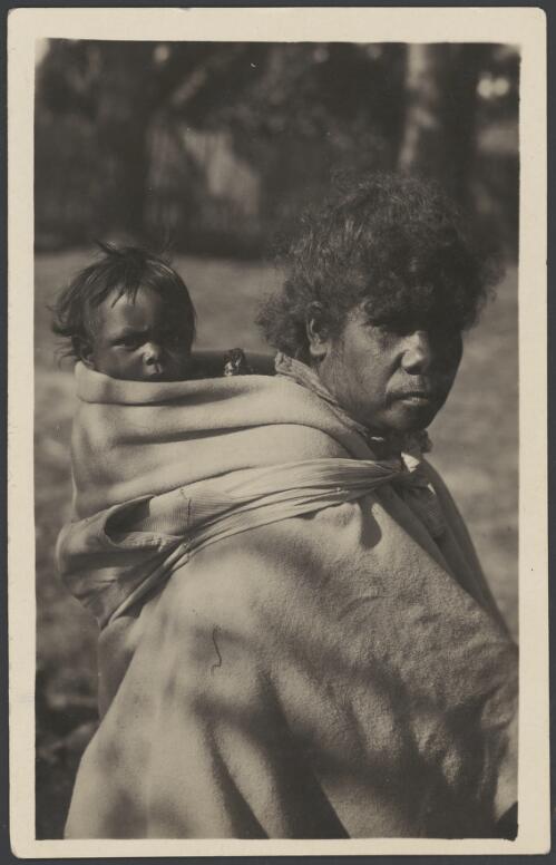 Aboriginal mother, wearing missionary clothing, with her child on her back in a sling at the Lake Tyers Mission, Lake Tyers, Victoria, ca. 1910 [picture]