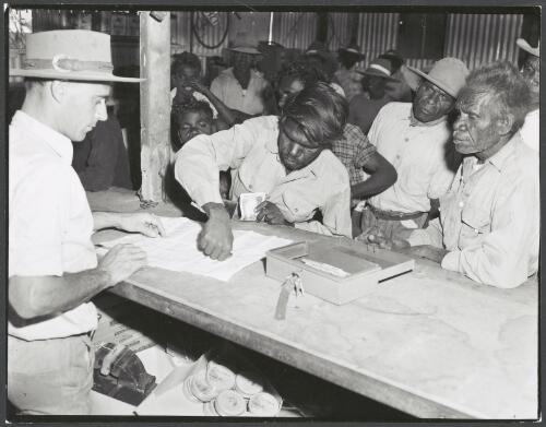 Aboriginal man paying for goods with cash and thumb print signature in Hooker Creek Mission store, Hooker Creek, Northern Territory, 1958 [picture] / Australian Information Service photograph