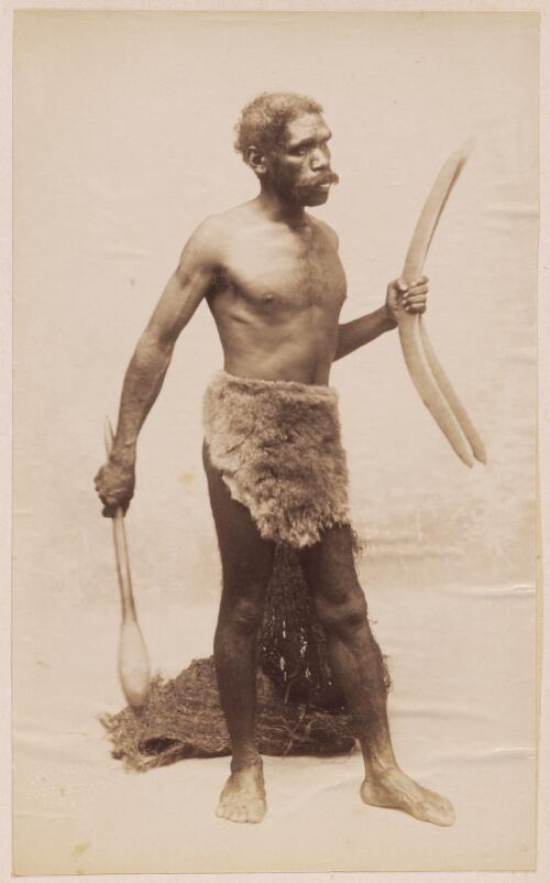 Aboriginal man holding a club and boomerangs, New South Wales? / Kerry & Co. Photo
