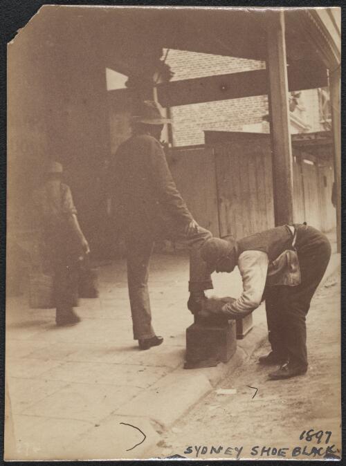 Shoe black polishing man's shoes, Sydney, 1897