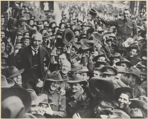 [Portrait of Hughes being carried by soldiers along a crowded street, 1919] [picture]