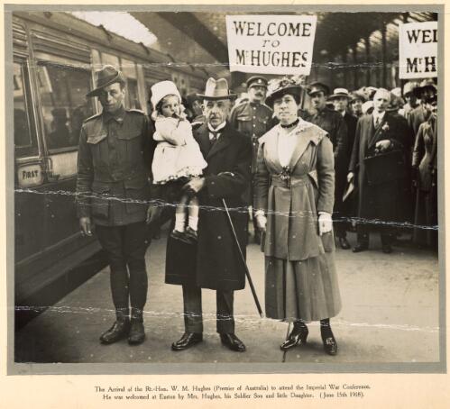 The arrival of the Rt.-Hon. W.M. Hughes (Premier of Australia) to attend the Imperial War Conference, he was welcomed at Euston by Mrs Hughes, his soldier son, and little daughter, 15 June 1918 [picture]