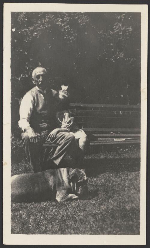 [William Morris Hughes sitting on outdoor bench, with daughter Helen? and dog] [picture]