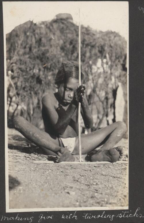Young Aboriginal boy making fire with a twirling stick, Broome, Western Australia, ca. 1926 [picture] / photos by R. A. Bourne