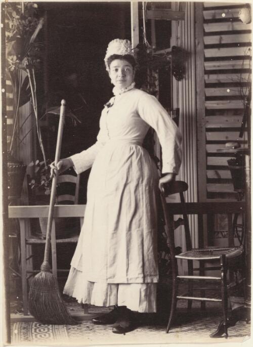 Girl in an apron holding a broom, France [picture] / J. Chester Jervis
