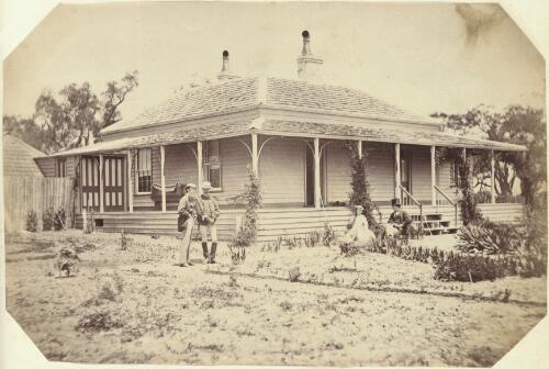 Four people in front of a new timber house with a verandah, Victoria [picture] / J. Chester Jervis