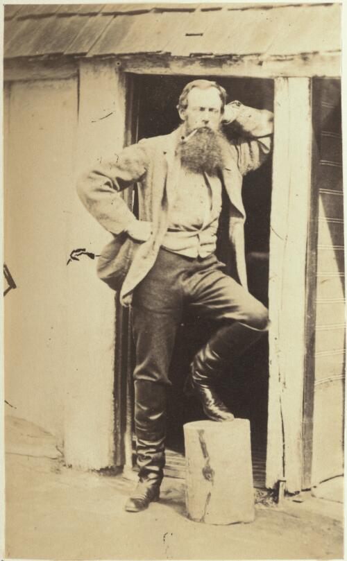 Bearded man wearing riding boots in a doorway, Victoria [picture] / J. Chester Jervis