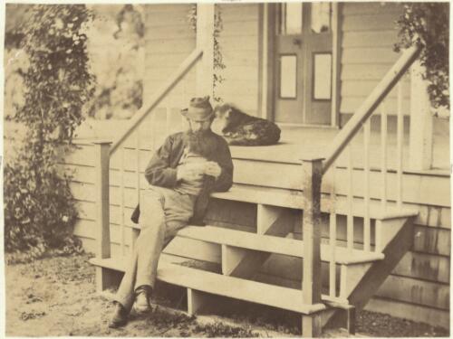 Man sitting on verandah steps with a dog, Victoria, ca. 1866 [picture] / J. Chester Jervis