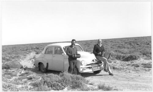 On the Nullarbor Plain, somewhere near the 'Head of the Gulf', Peter Ellis and John Meredith serenade the wilderness during their great coast to coast field trip in 1991, travelling in Peter's original FJ Holden [picture]