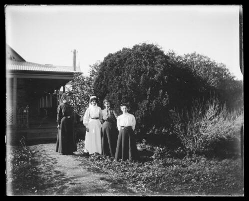 Nurse and three women standing near a verandah at Kimo, New South Wales [picture] / Charles Gabriel