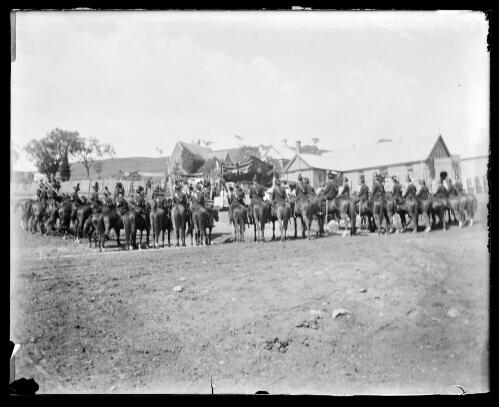 A contingent of Light Horse outside St. John's Hall in Gundagai, Rectory and church in  background [picture] / Charles Gabriel