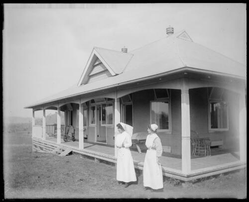 Two nurses outside the isolation ward of the old hospital, Gundagai, New South Wales, 2 [picture] / Charles Gabriel