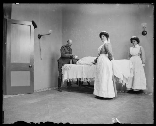 Army doctor, Matron Young and a nurse in the operating theatre in the new hospital, Gundagai, New South Wales [picture] / Charles Gabriel