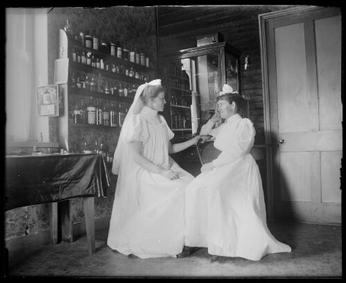 Two nurses in the dispensary of the old hospital, Gundagai, New South Wales, ca. 1900 [picture] / Charles Gabriel