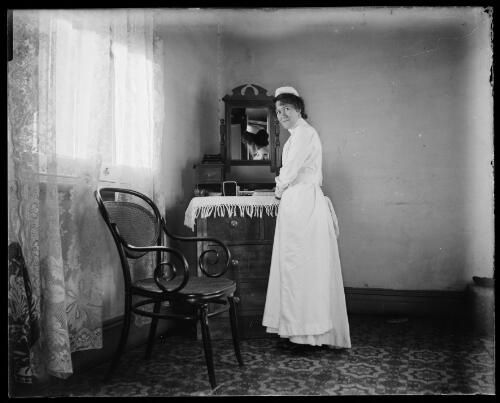 Portrait of a nurse standing by a dresser, Gundagai, New South Wales, ca. 1900 [picture] / Charles Gabriel