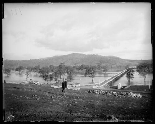 Man standing on the bank of the Murrumbidgee River in flood, Gundagai, New South Wales [picture] / Charles Gabriel
