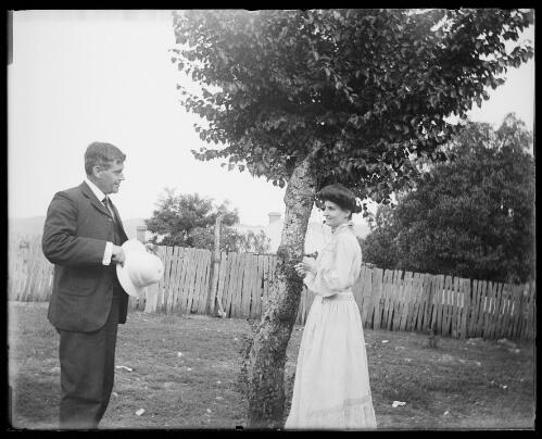 Wallace Robinson, later Mayor of Gundagai, standing with a nurse in a garden, Gundagai, New South Wales, between 1900 and 1915 [picture] / Charles Gabriel