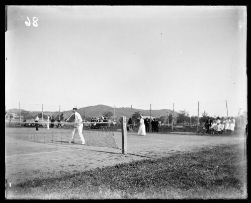 Man and woman playing tennis on Weeks' tennis court, Gundagai, New South Wales [picture] / Charles Gabriel