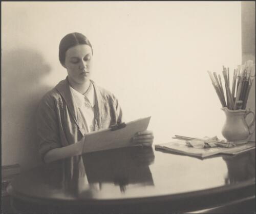 Nora Heysen seated at the table and sketching, 9th March,1939 / Harold Cazneaux