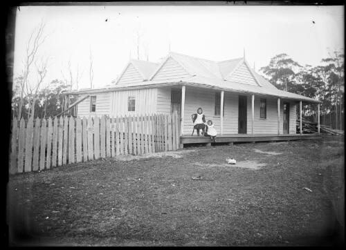 [Two young girls on the verandah of a house] [picture] / [William Henry Corkhill]