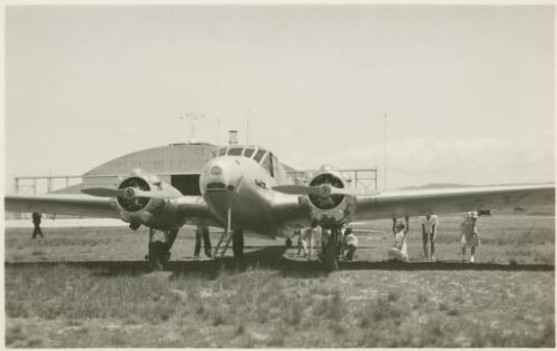 The Royal Australian Air Force Avro Anson parked at Canberra Airport, with a hangar in the background ca. 1940s [picture] / R.C. Strangman