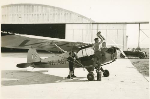 The Piper J-3C-40 Cub, VH-ACF, light aircraft being refuelled at Canberra Airport, ca. 1939 [picture] / R.C. Strangman