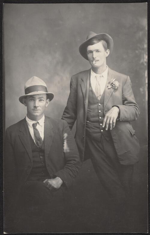 Portrait of two men in suits, one is smoking, Tumut, New South Wales  / R.C. Strangman