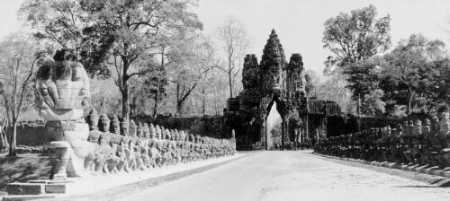 [Gates of Angkor Thom, view from southern gate, rows of sculptures line entrance gate] [picture] / Yves Coffin