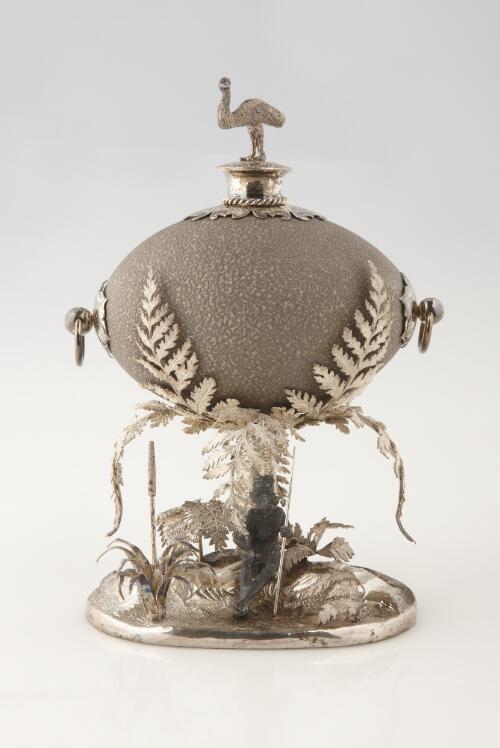 [Emu egg on silver-plate stand with Aboriginal, fern and emu decoration] [realia]