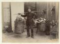 [Portrait of unidentified Chinese fruit and vegetable hawker with baskets of produce] [picture]