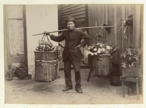 [Portrait of unidentified Chinese fruit and vegetable hawker with baskets of produce] [picture]