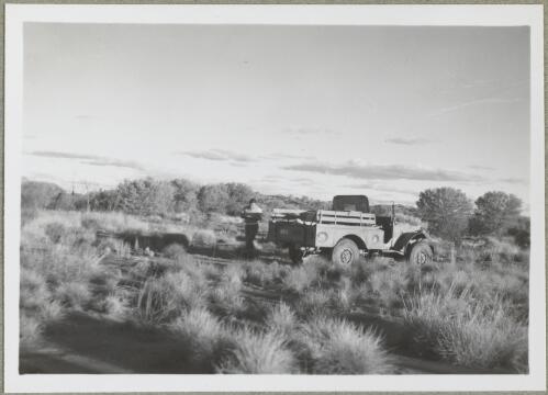 Unidentified man and a light truck in the desert grassland? Northern Territory, 1947 [picture] / Arthur Groom