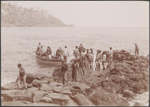 Men landing supply boat from the Southern Cross at the Cascades, Norfolk Island, 1906 / J.W. Beattie