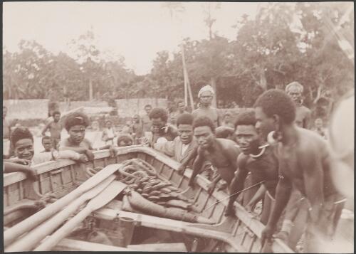 Solomon Islanders lifting row boat, Solomon Islands, 1906 / J.W. Beattie