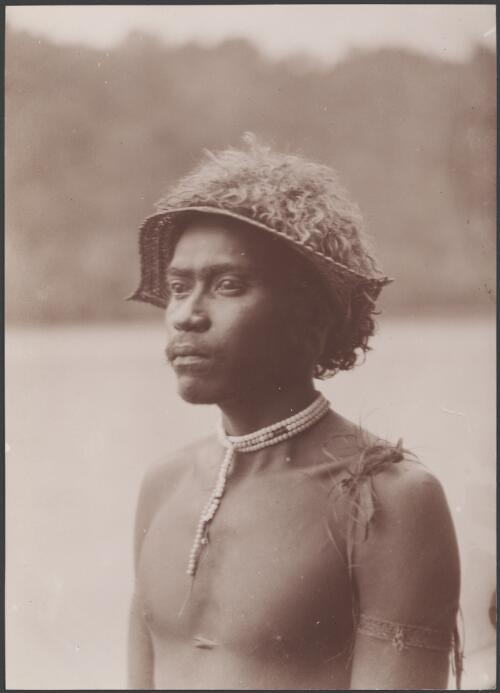 A young man of Vella Lavella wearing sunshade, Solomon Islands, 1906 / J.W. Beattie