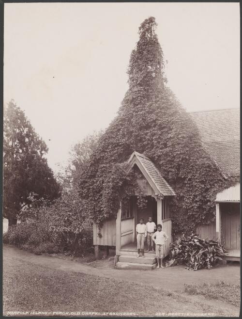 Three boys on the porch of the old chapel at St. Barnabas, Norfolk Island, 1906 / J.W. Beattie
