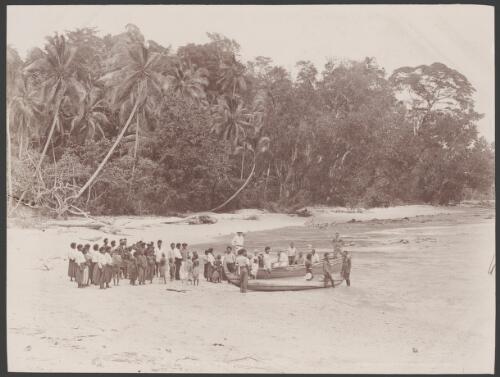 Missionaries and villagers gathered around boats on a Fagani beach, Solomon Islands, 1906 / J.W. Beattie