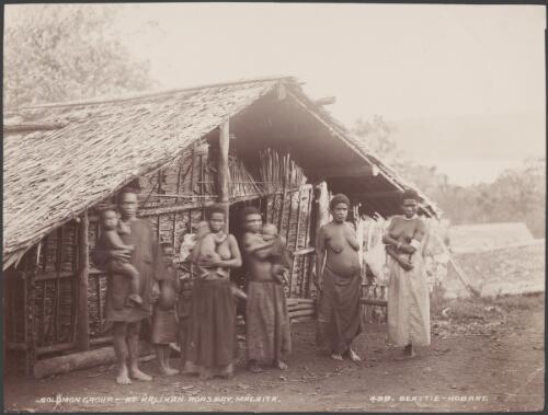 Villagers standing outside a building at Halihan, Malaita, Solomon Islands, 1906 / J.W. Beattie
