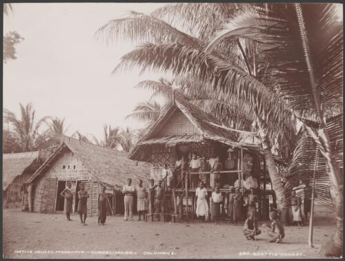 Villagers gathered outside a house in Maravovo village, Guadalcanar, Solomon Islands, 1906 / J.W. Beattie