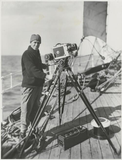 Captain Frank Hurley with a camera on board the Discovery, ca. 1931 [picture] / Frank Hurley
