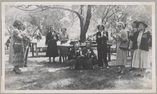Jacqueline Smith (wearing suit) standing with other Australian Women Pilots' Association members having a barbecue in a park, Adelaide, 1953 [picture]