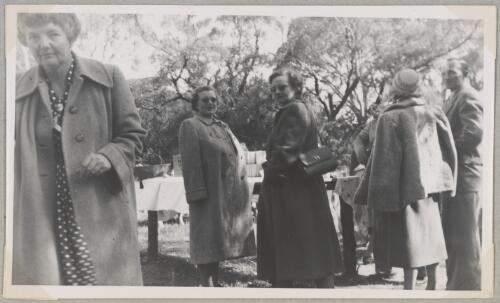 Small group standing near picnic tables at an Australian Women Pilots' Association barbecue in a park, Adelaide, 1953 [picture]