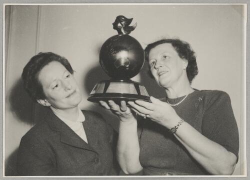 Marie Richardson holding Australian Women Pilots' Association Air Reliability Trial trophy with Nancy Walton, Melbourne, October 1955 [picture]