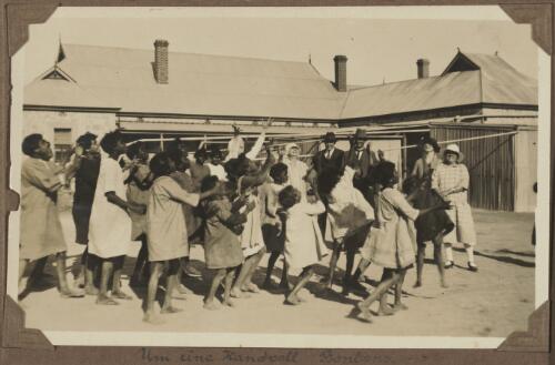 Aboriginal Australian children reaching for sweets that have been thrown into the air, Koonibba, South Australia, ca. 1925 [picture]