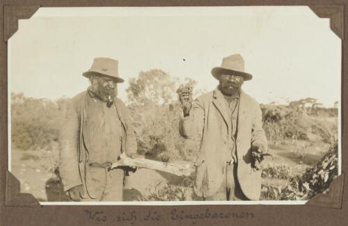 Two elders holding a piece of wood, grass and a stick for fire lighting, Koonibba, South Australia, ca. 1925 [picture]