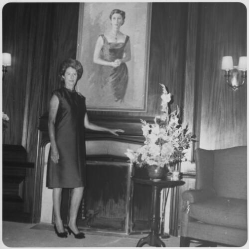 Lady Waller standing by the fireplace in the Australian Embassy library, Washington DC, approximately 1967