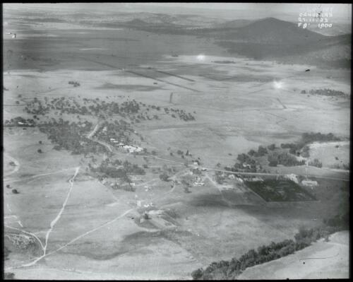 Early aerial view of Acton, 1920. Shows Acton Offices, Nursery, Acton Guest House, Canberra House, plantings on London Circuit, Northbourne Avenue, Mount Ainslie [picture] / W.J. Mildenhall