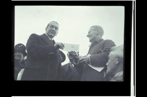 Presentation of cheque to Kingsford Smith by PM Bruce [picture] / W.J. Mildenhall