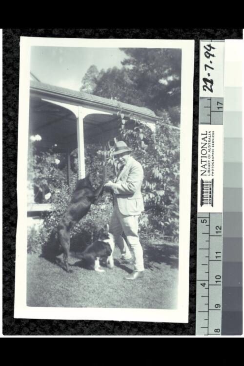 Edgar Herring and his dogs in the garden at 'Sheen' [picture]